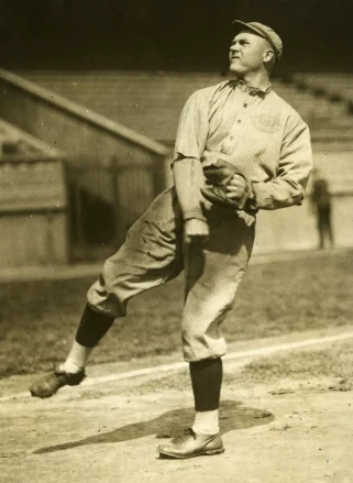 Walter Johnson in a vintage photograph, glove in hand on the mound